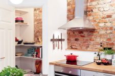 12 a chic Scandinavian kitchen with red touches and a red brick backsplash for a texture and bolder look
