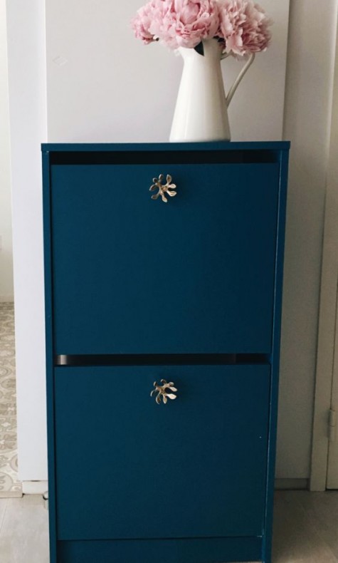 A bold blue IKEA Bissa cabinet with catchy brass knobs looks really expensive and very whimsy thanks to knobs