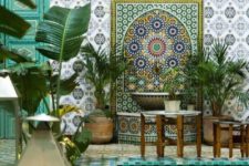13 a colorful Moroccan pool space with several tiles of gorgeous tiles, potted greeneyr, vintage furniture and lanterns