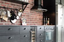 13 a dark masculine kitchen is spruced up with a red brick backsplash for more texture and shiny metal touches