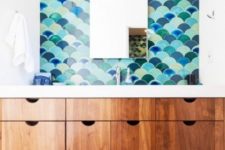 13 sea-inspired colorful fishscale tiles make a statement in this sink space and make it stand out
