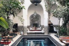 14 a gorgeous Moroccan pool space with hanging lanterns, bright furniture, loungers, mosaic tiles and pillars