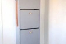 15 a light grey IKEA Bissa cabinet with elegant gilded knobs is a perfect entryway storage unit