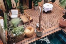15 a warm-colored Moroccan pool space done with wicker and leather furniture, potted plants, hanging lanterns and a pool with steps