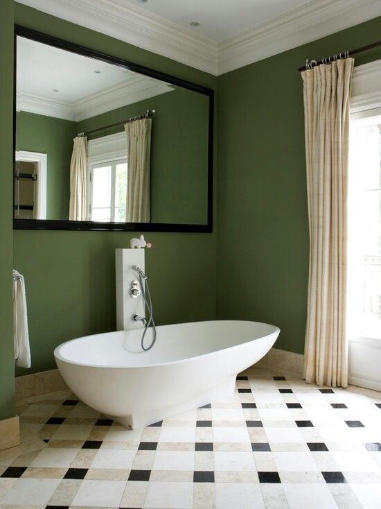 a whimsy mid century modern bathroom with a large mirror over the bathtub for a catchy look