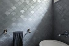15 ultra-modern bathroom with gray metallic fishscale tiles and a white egg-shaped free-standing sink