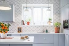 16 a matte grey kitchen with a white fishscale tile backsplash that is spread on the whole wall