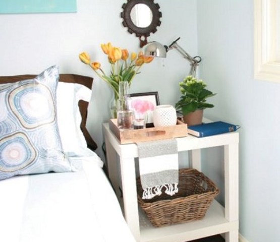 a stylish and functional nightstand of a couple of IKEA Lack tables is an easy DIY with much open storage space