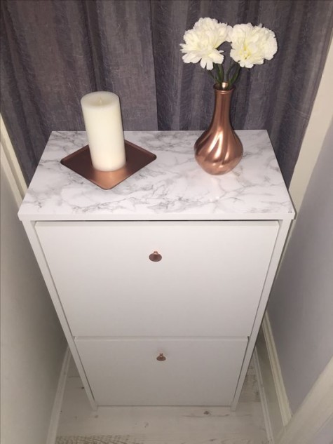 an IKEA Bissa hack done with copper knobs and marble contact paper is a glam idea with a trendy feel