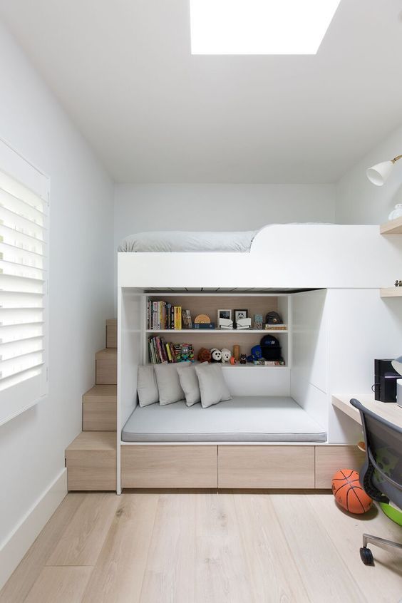 a small kid's space with a built in bed and seat unit plus a desk on the side for an ultimate look
