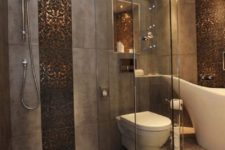 18 copper penny tiles accent the grey bathroom and give it a luxurious feel, I love the way they bling