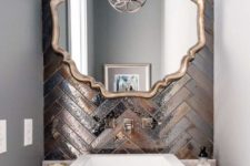19 copper and silver shiny tiles clad in a chevron pattern will make your sink space very statement-like