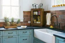 20 a blue shabby chic blue kitchen with dark countertops and a red faux brick backsplash for a texture