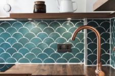 21 a contemporary kitchen with butcher block countertops, wooden shelves and teal fishscale tiles