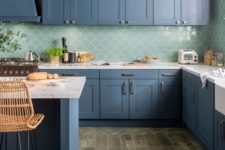 24 a beautiful blue kitchen with white stone countertops and a green fishscale tile backsplash