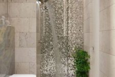 24 silver mosaic tiles and greenery make the shower space really outstanding and very bold