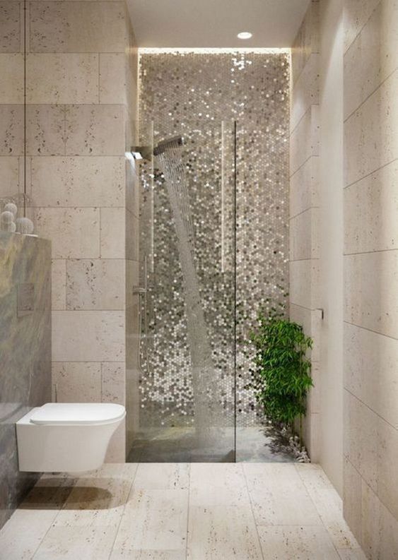 silver mosaic tiles and greenery make the shower space really outstanding and very bold