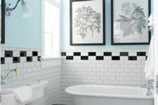25 a pretty small bathroom with black and white botanical artworks over the bathtub