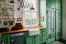 a bright green kitchen with butcher block countertops that contrast the cabinets and calm them down