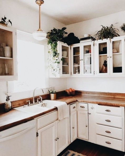 a creamy kitchen done with rich-colored butcher block countertops for a more natural look