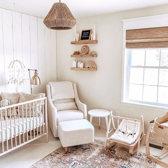 a neutral farmhouse nursery with wooden furniture and woven shades and lamps plus printed rugs