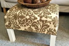 a plain and old IKEA Lack end table turned into a stylish ottoman with bright printed fabric