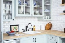 a powder blue vintage-inspired kitchen with light-colored butcher block countertops