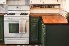 a two tone kitchen in green and white and stained butcher block countertops for a touch of warm color