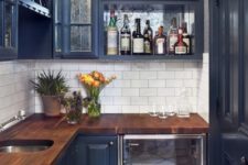 teal cabinets with rich-stained butcher block countertops and a white subway tile backsplash looks very bold