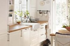 vintage white cabinets with light-colored butcher block countertops for a cozy feel and touches of blue