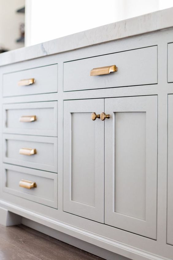 dove grey cabinets with copper handles and knobs are a stylish combo for a chic space