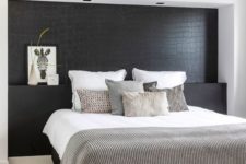 06 a Nordic bedroom with a black statement wall that imitates reptile skin and is a unique and dramatic accent