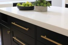 06 long brass handles stand out on black cabinets and make the kitchen look wow