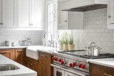 10 a modern farmhouse kitchen with white uppers and rich stained lower ones plus a white subway tile backsplash