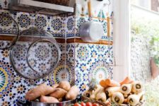 10 a neutral kitchen with polished metal countertops and an extra bold Mediterranean tile backsplash is wow