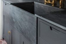 12 a moody graphite grey kitchen with a black marble backsplash and countertops, gold touches for more chic