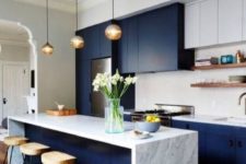 13 bold blue and white cabinets plus a marble kitchen island look modern and luxurious