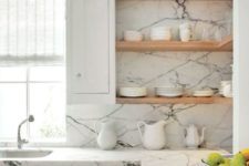 a white marble makes this kitchen looks gorgeous