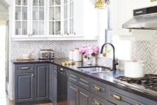 20 grey and white cabinets with a chevron tile backsplash and brass touches plus a blue rug