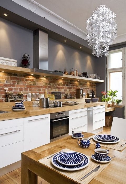 a brick backsplash adds texture and interest to the space and contrasts the sleek countertop