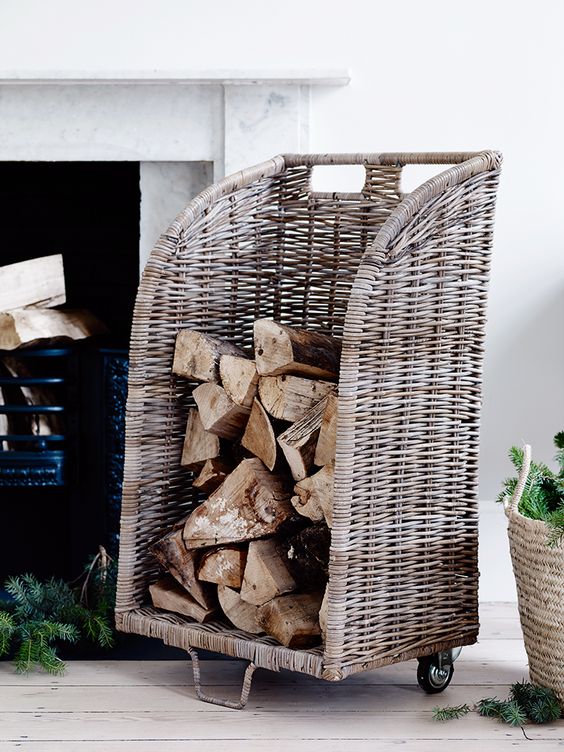 a natural rattan firewood stand on casters is a very comfy thing that is sure to add a touch of rustic aesthetics to the space