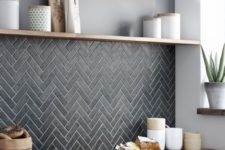 24 graphite grey tiles clad in a chevron pattern and look stylish with butcher block countertops