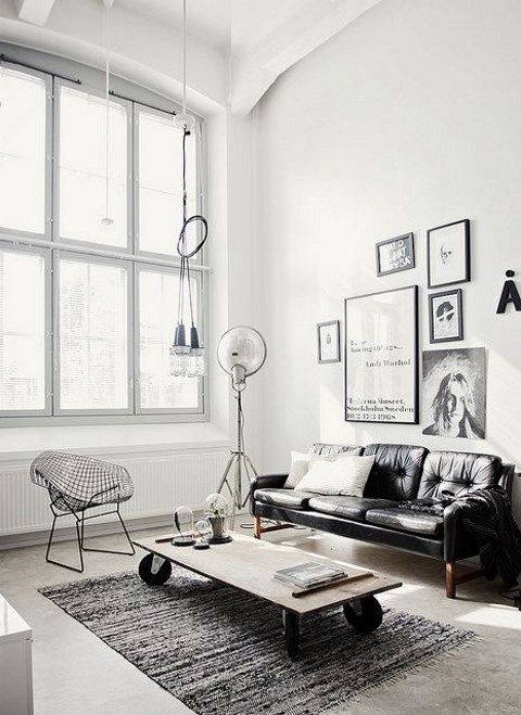 a Scandinavian meets industrial living room with monochromatic decor, cool industrial furniture and lamps