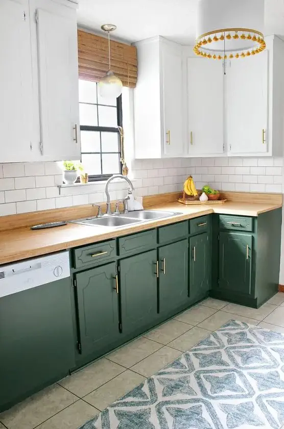 https://i.shelterness.com/2020/04/a-beautiful-olive-green-and-white-kitchen-with-catchy-cabinets-butcherblock-countertops-a-white-pendant-lamp-with-pompoms.jpg