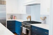 a bold blue and white mid-century modern kitchen with white countertops and a metal cooker