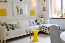 a bold contemporary living room with a white brick wall and a gallery wall with lots of signs, lights and artworks