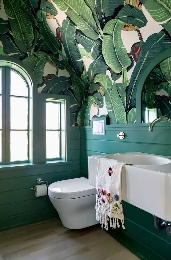 a lovely tropical bathroom in green shades