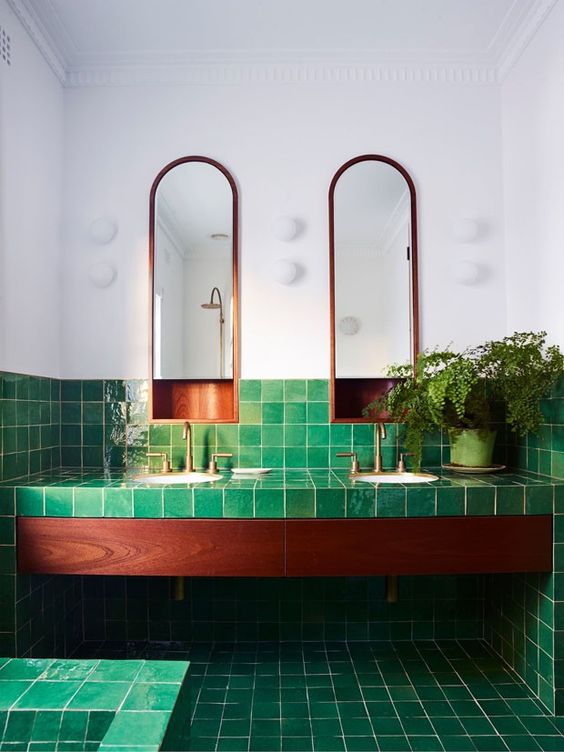 a catchy and bold bathroom clad with bright green tiles and rich stained wood is gorgeous