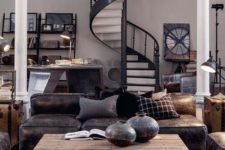 a catchy industrial living room with a leather sofa, metal and wood furniture that catches an eye and lamps here and there
