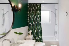 a contemporary bathroom with gray hex tiles, a green and white wall, a tropical print curtain and a large vanity